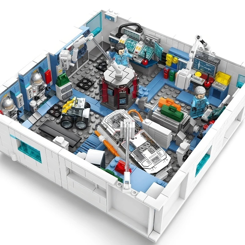 A toy space station with three figures, a vehicle, and various equipment.