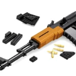 A toy gun with a gold-colored grip and several black building blocks and gold-colored bullets are shown.