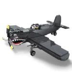 A black toy airplane with a shark mouth design and a pilot figure inside.