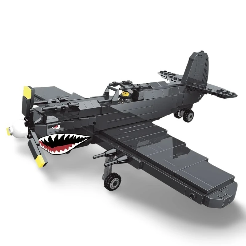 A black toy airplane with a shark mouth design and a pilot figure inside.