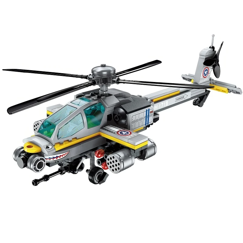 Gray and yellow toy helicopter with rotating blades, missiles, and a shark mouth design.