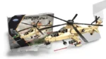 A beige toy helicopter with black rotors and red missiles is next to its box.