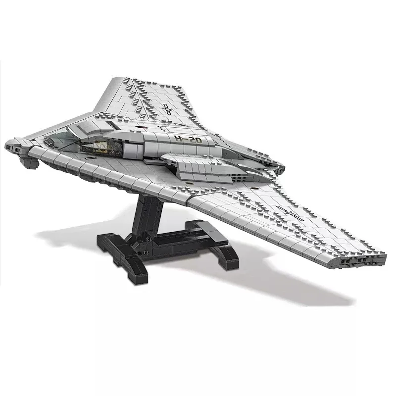 A gray toy spaceship model sits on a black stand.
