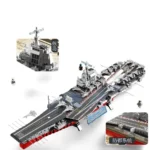 A toy aircraft carrier with several toy planes and two small figures is displayed.