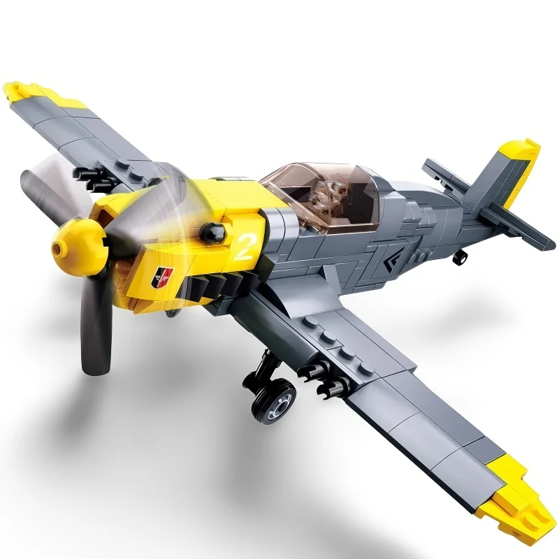 A toy airplane with gray and yellow bricks has a propeller and a pilot figure inside.