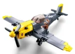 A gray and yellow toy airplane with a small figure standing on the wing.