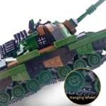 A toy tank with green, brown, and black blocks, featuring a white cross symbol and multiple wheels.