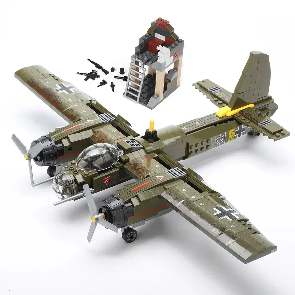 A toy airplane with two propellers, a small building, and several toy weapons are visible.