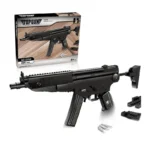 A black toy assault rifle and its box are displayed along with some additional pieces.