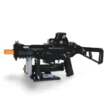A black toy gun with an orange tip sits on a stand.
