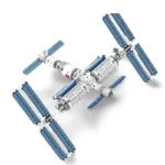 A toy space station model with blue solar panels and white modules.