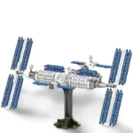 A toy space station with solar panels is displayed on a stand.