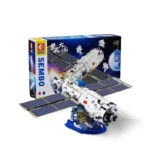 A toy satellite model with solar panels and its box are displayed.