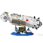 A white and gold space station model is displayed on a blue stand.