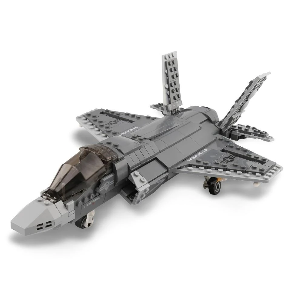 A gray toy jet airplane with a transparent cockpit and landing gear.