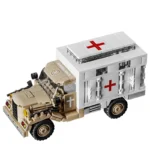 A tan and white toy ambulance truck with red crosses on the side and top.