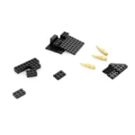 Black toy bricks and gold-colored toy bullets are scattered on a white surface.