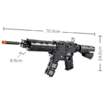 A black toy gun with an orange tip is displayed with its dimensions.