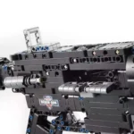 A black toy gun made of building blocks with silver and blue accents.