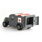 A gray toy ambulance with a red cross on the side and top, and open back doors.