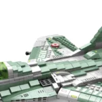 A toy airplane model with green and white blocks, and a red star.