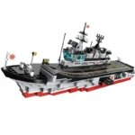 A toy ship with a black deck, white and red hull, and two flags is displayed.