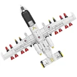 A white toy airplane with red and gold missiles attached to the wings.