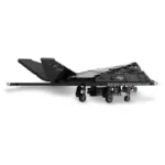 A black toy stealth aircraft with wheels and a tail is displayed.