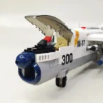 A toy airplane with an open cockpit, a blue nose, and the number 300 on its side.