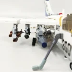 A white toy airplane with missiles and a refueling arm is shown.