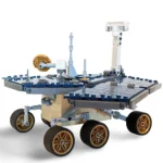 A toy rover with four wheels, a flat top, and various antennas and sensors.