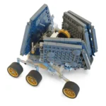A toy rover with four black and gold wheels and blue panels is visible.