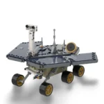 A toy rover with six black wheels and a gray body, featuring solar panels and antennas.