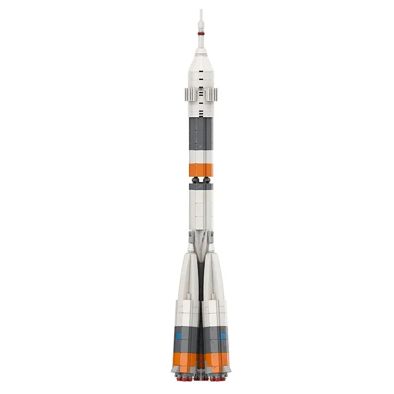 A toy rocket with white, gray, and orange sections, stands upright.