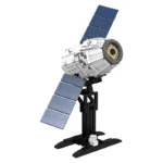 A toy satellite with solar panels sits on a black stand.