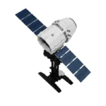 A toy satellite with two blue solar panels is attached to a black stand.