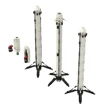 Three white toy rockets stand upright, with additional rocket parts to the left.