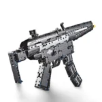 A black and gray toy gun made of building blocks with blue accents is displayed.
