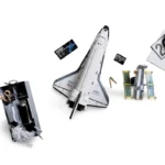 A toy space shuttle, a satellite, and a box with tools are displayed.