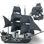 A black brick toy ship with multiple sails is displayed with a smaller version in the background.