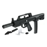 A black toy gun with several toy bullets and additional black bricks on a white surface.