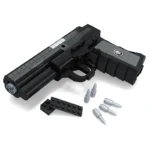 A black toy pistol with a gray star on the handle, four gray bullets, and two black rectangular pieces are displayed.