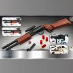 A toy shotgun with brown and black parts is displayed alongside additional toy weapons and red cylindrical pieces.