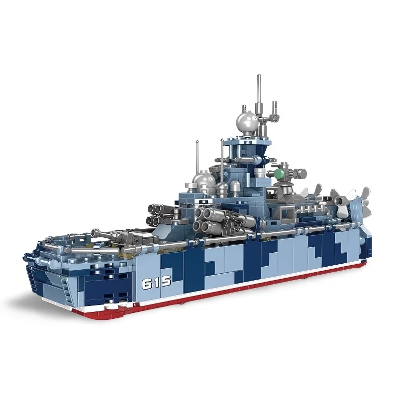 A toy warship with camouflage pattern, multiple guns, and a number 615 on its side.