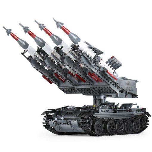 A gray toy tank with a missile launcher and four missiles is shown.