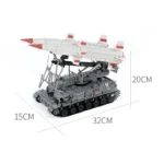 A gray toy tank with two white missiles on top is displayed.