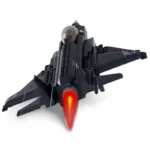 A black toy jet with a red flame coming from the back.