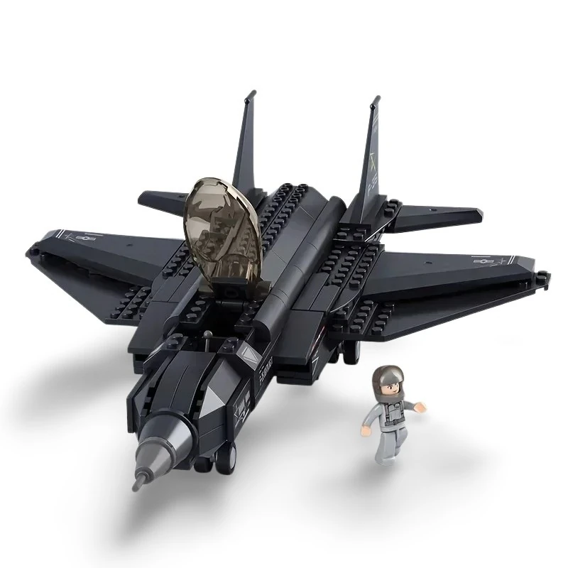 A black toy jet and a small figure in a gray suit are on a white surface.