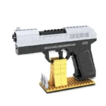 A toy gun made of interlocking bricks is displayed on a stand with four bullets.