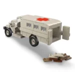 A toy ambulance truck with a red cross on the roof and several small rectangular pieces are visible.